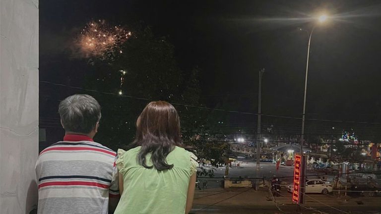 Ba mẹ tôi cùng ngắm pháo hoa trước cửa nhà.