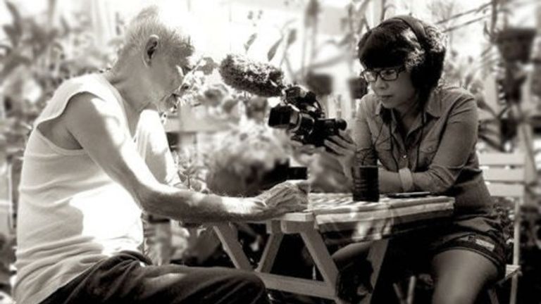 Director Doan Hong Le (right) with her father (left) during a filming.