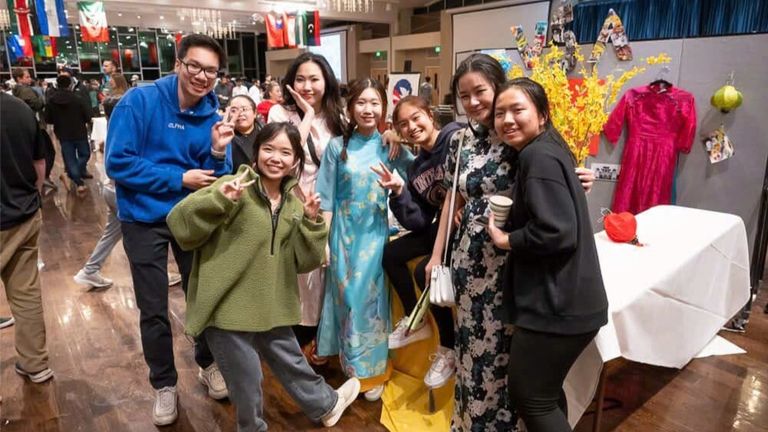 Vietnamese students wearing ao dai at the stall in Boston. | Source: Ha My for Vietcetera