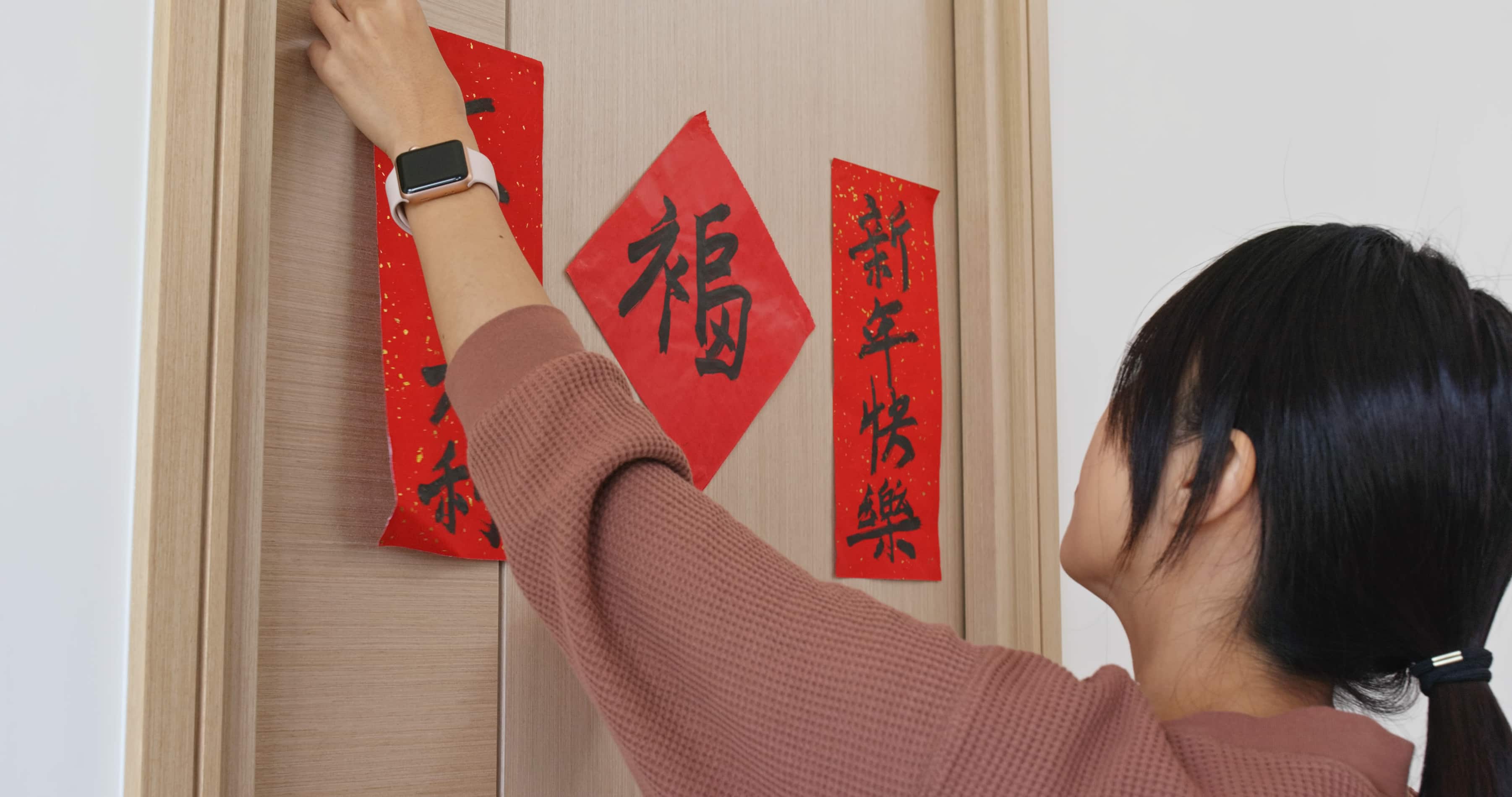Source Shutterstock titlePerson decorating home for Lunar New Year Tet Source ShutterStock Person decorating home for Lunar New Year Tet Source ShutterStock