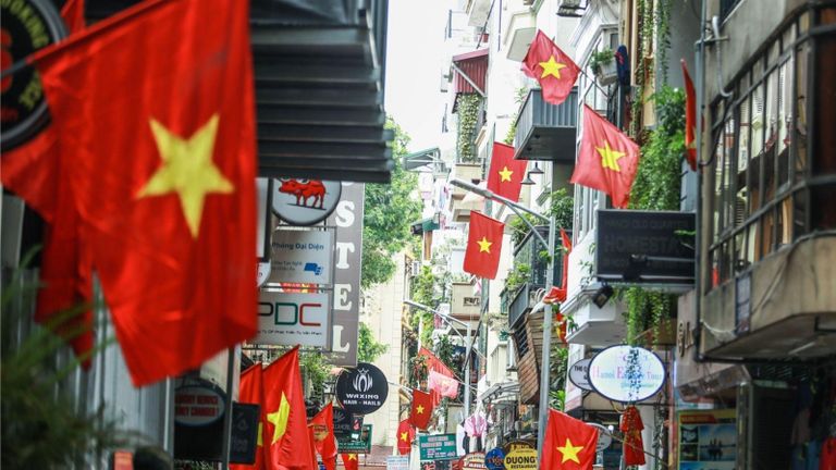 Vietnam’s national flags shine brightly across the rooftops of the capital. | Source: Reatimes