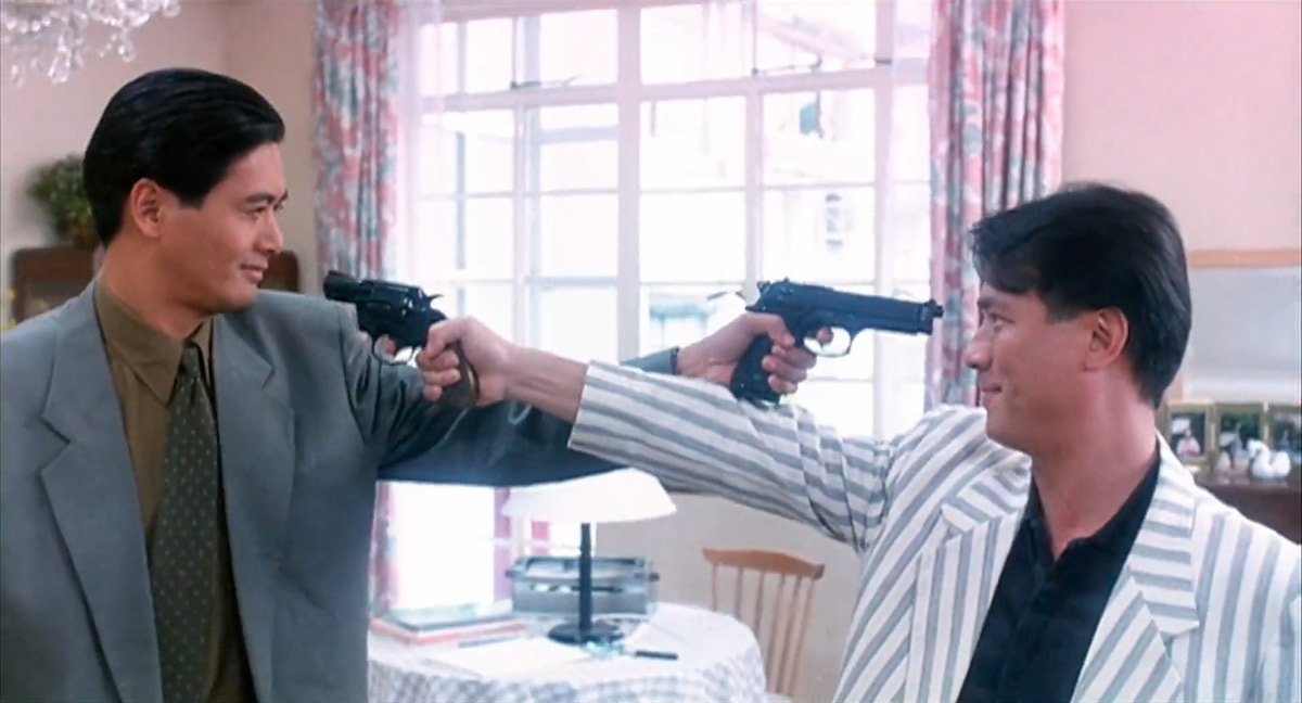 A John Woo’s typical Mexican standoff set-up | Source The Killer standoff