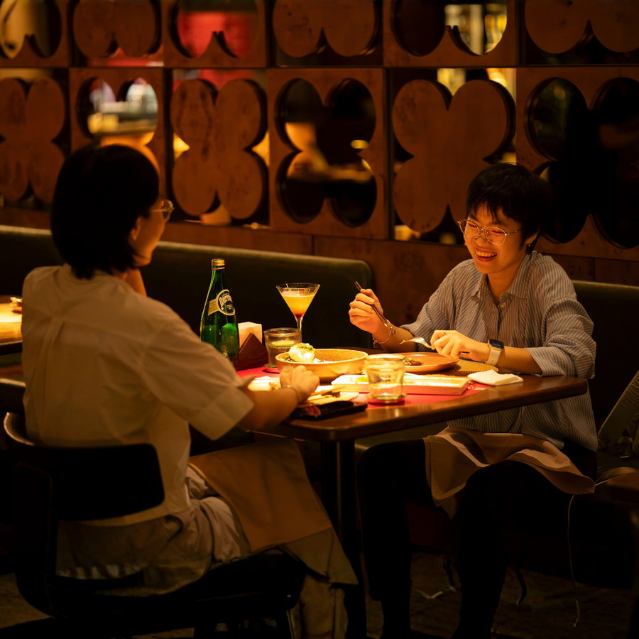 Guests in the warmly lit Mâm Mâm lounge