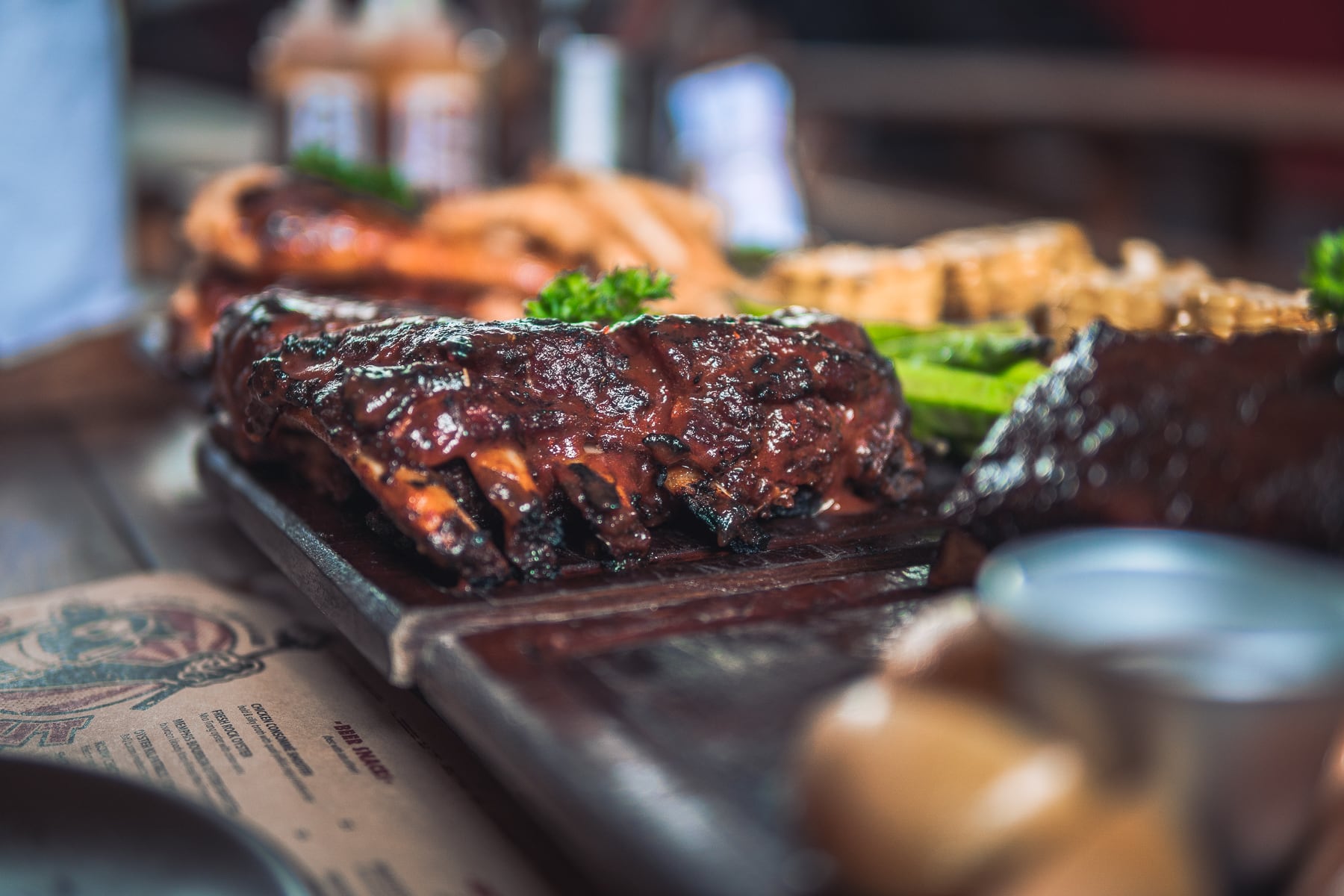 Quan Ut Ut’s cashew smoked pork ribs are served alongside seasoned grilled okra and corn on the cob Quan Ut Ut’s cashew smoked pork ribs are served alongside seasoned grilled okra and corn on the cob sizesmaxwidth 1800px 100vw 1800px